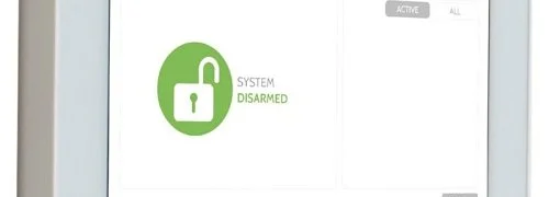 Wall-mounted alarm system touchscreen control panel showing disarmed status