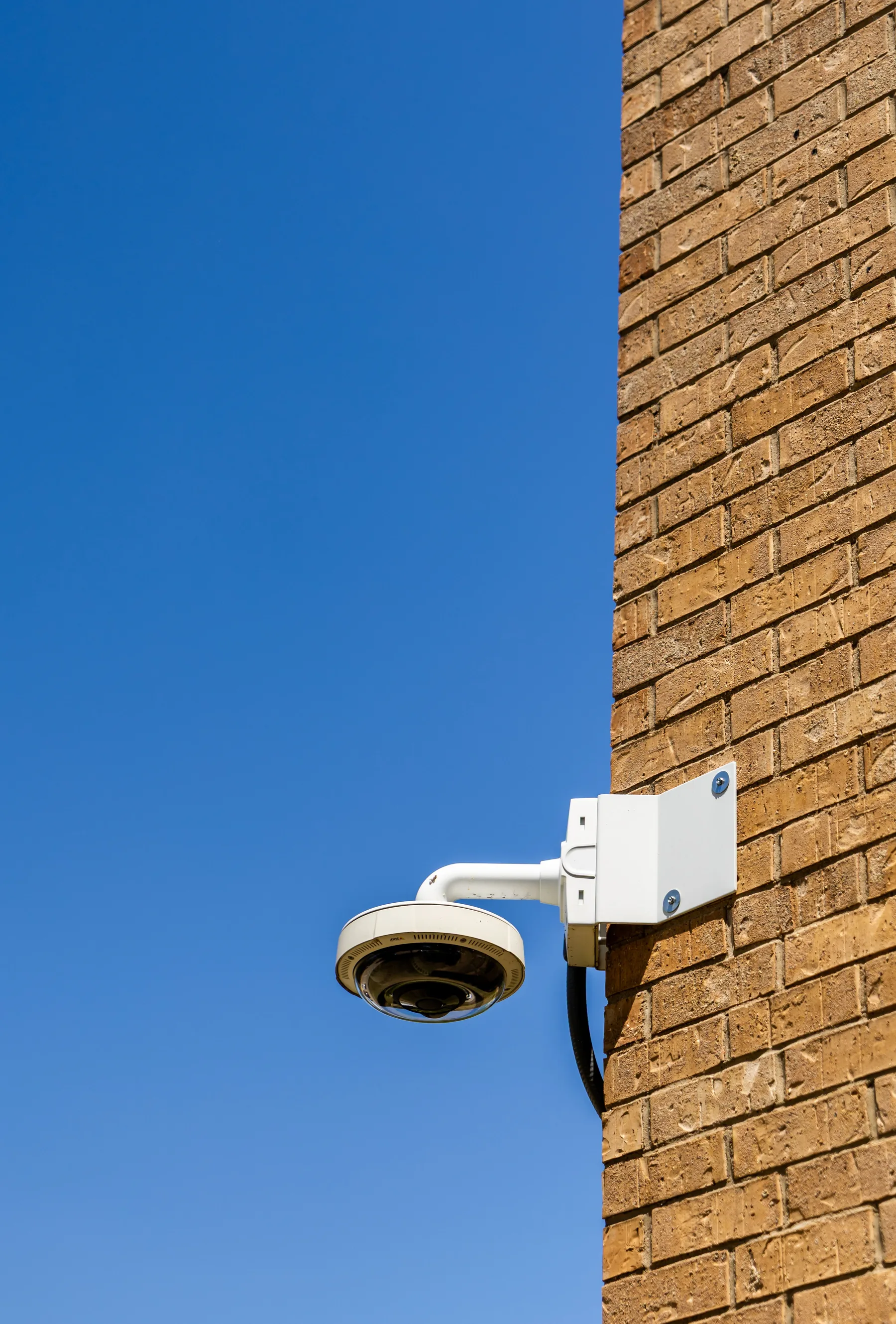 Security camera mounted on a brick exterior wall