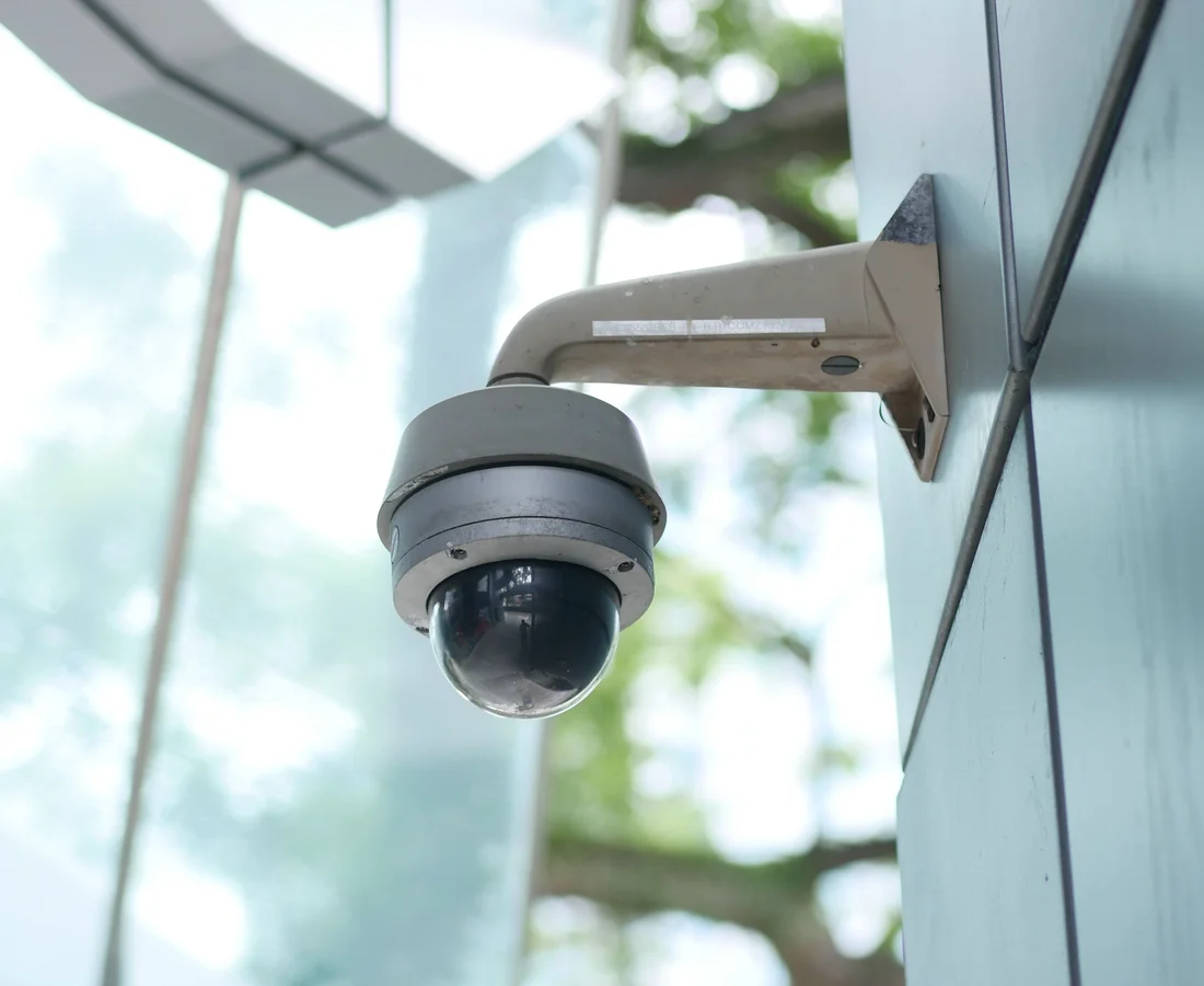 Security camera installed under a building eave