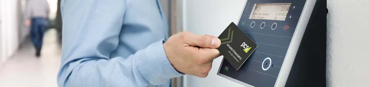 Employee tapping an access card against a wall-mounted card reader