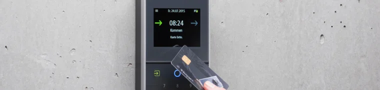 Hand tapping an access card against a wall-mounted keypad terminal