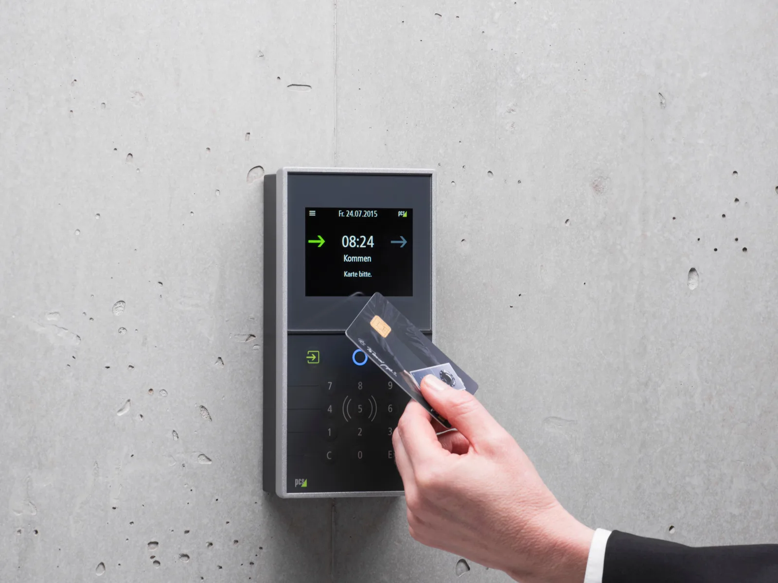 Hand tapping an access card against a wall-mounted keypad terminal